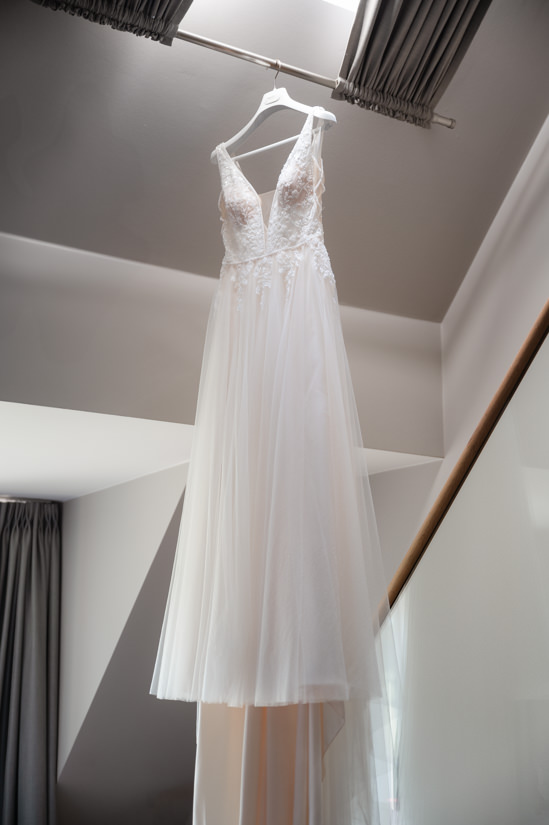 Brautkleid hängt im Hotelzimmer